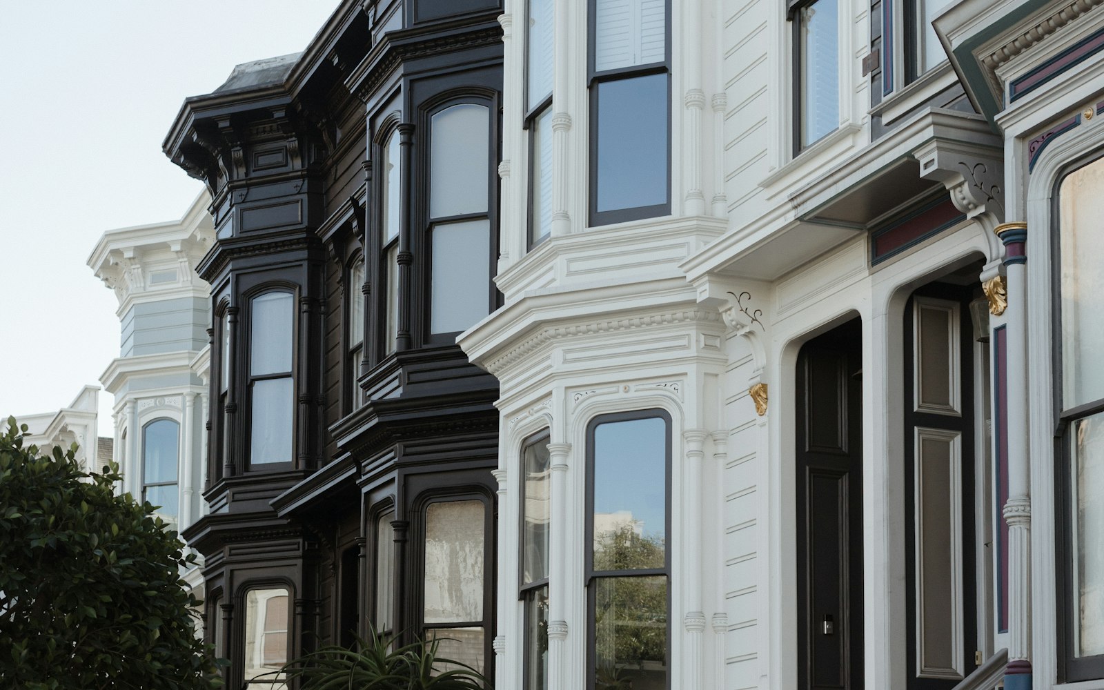Row of SF Victorian houses with bay windows and stepped entries